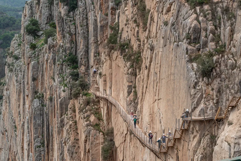 Visitors with safety helmets at the northern entrance gate of Caminito del Rey